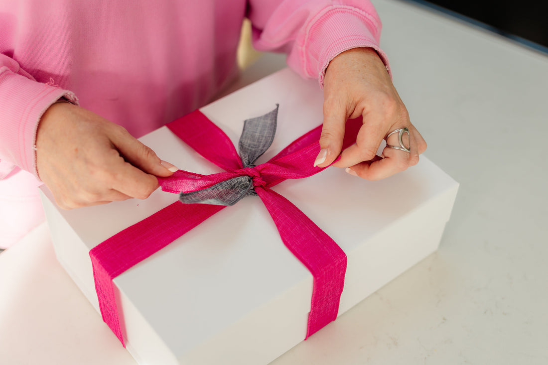 Female founder packing thoughtful client gift for business